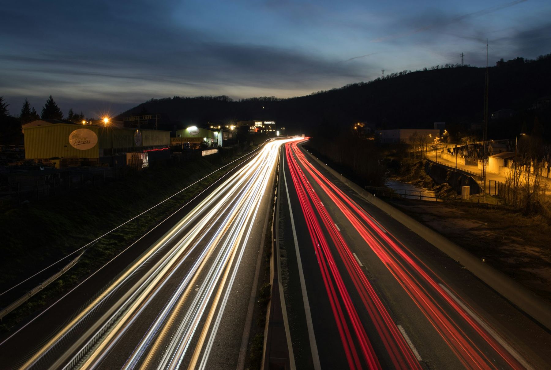 Light trails along a multi-lane highway at night