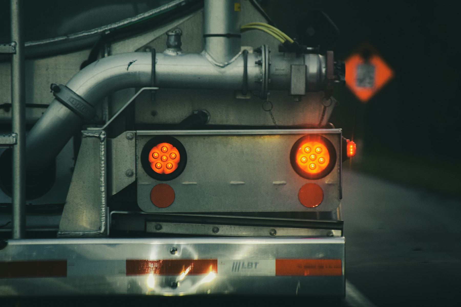 Close-up of a truck's red tail lights at night