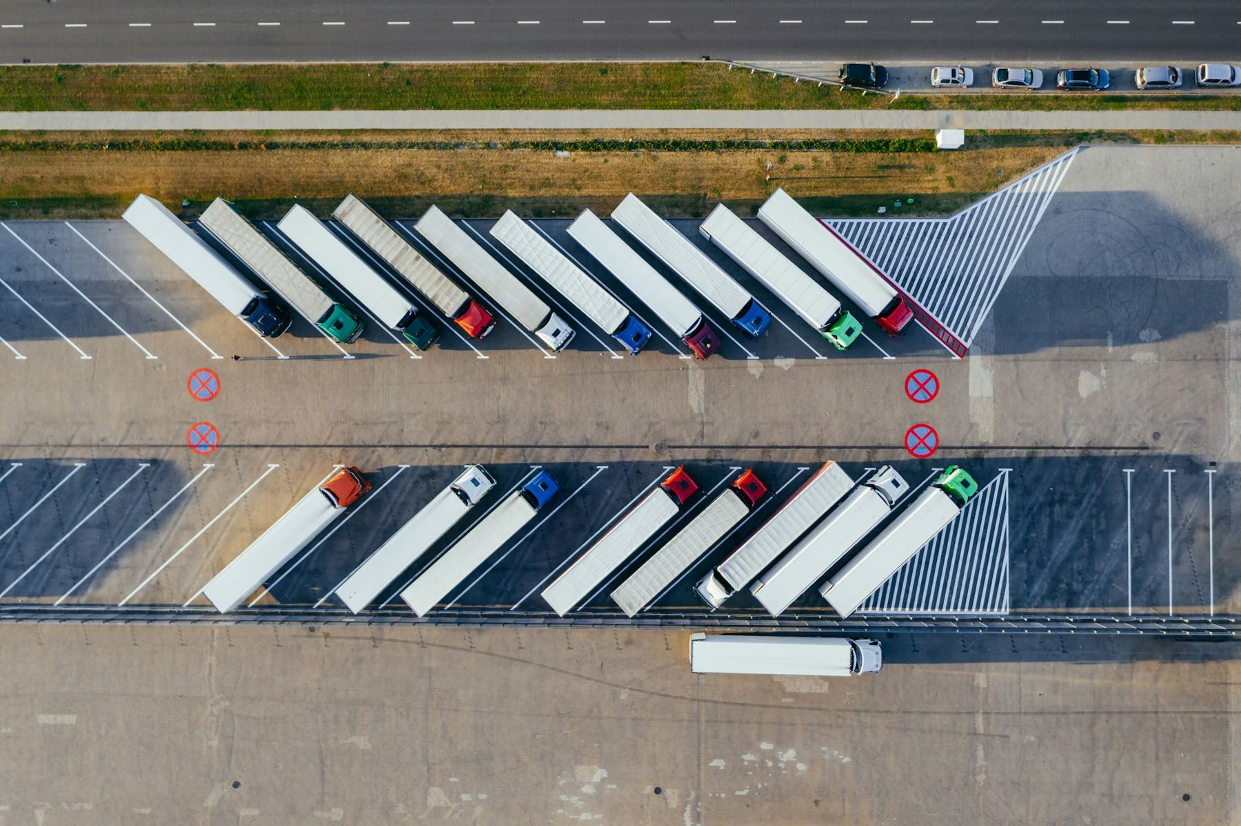 Aerial view of trucks parked in rows at a logistics yard